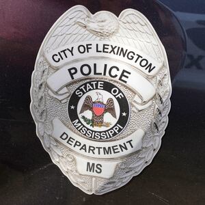 A police shield is displayed on a Lexington, Mississippi police cruiser