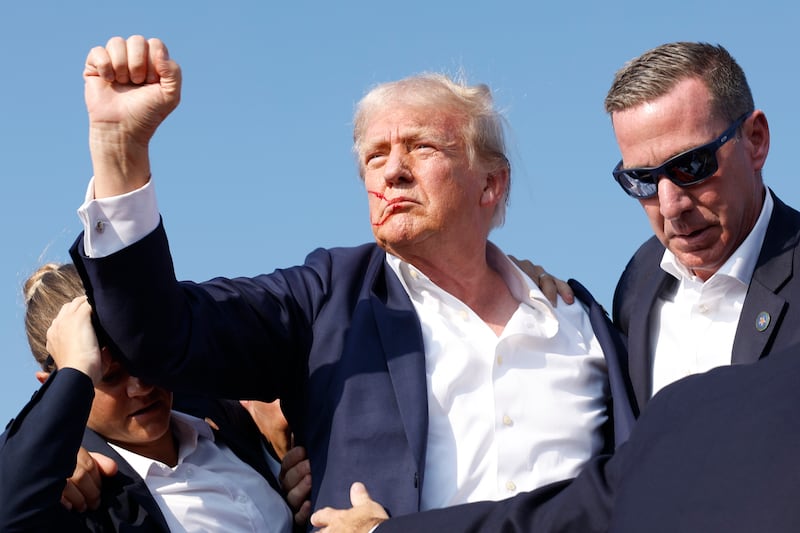 BUTLER, PENNSYLVANIA - JULY 13: Republican presidential candidate former President Donald Trump is rushed offstage during a rally on July 13, 2024 in Butler, Pennsylvania. Butler County district attorney Richard Goldinger said the shooter is dead after injuring former U.S. President Donald Trump, killing one audience member and injuring another in the shooting. (Photo by Anna Moneymaker/Getty Images)