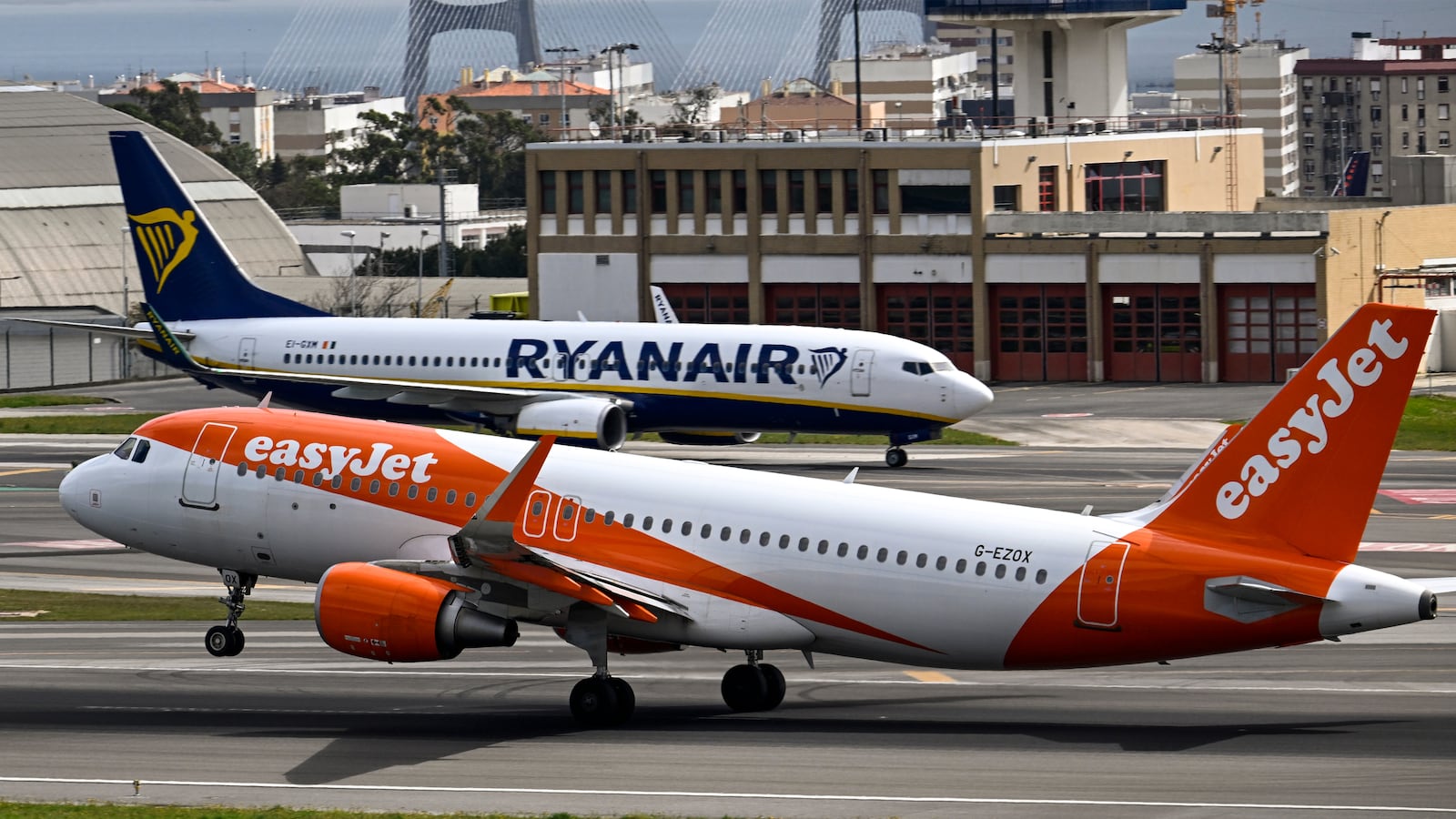 An easyJet aircraft moves past a Ryanair airplane in Portugal.