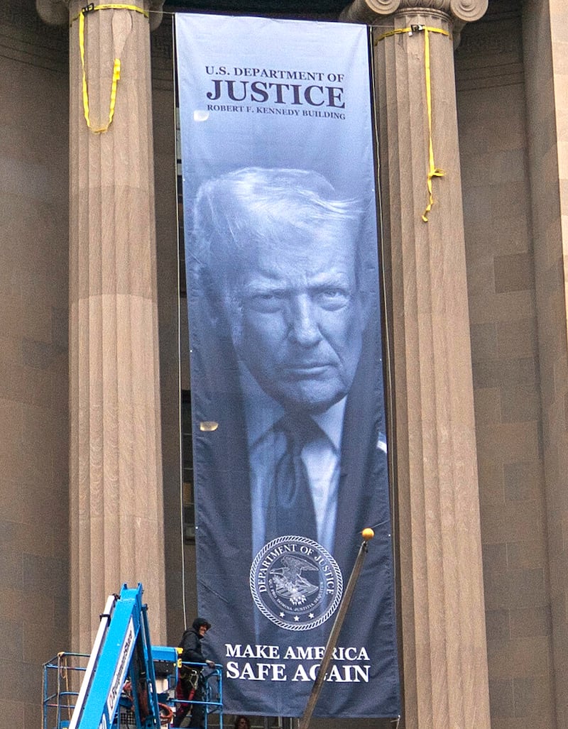A banner showing President Donald Trump is hung from the Department of Justice, Thursday, Feb. 19, 2026, in Washington, D.C.