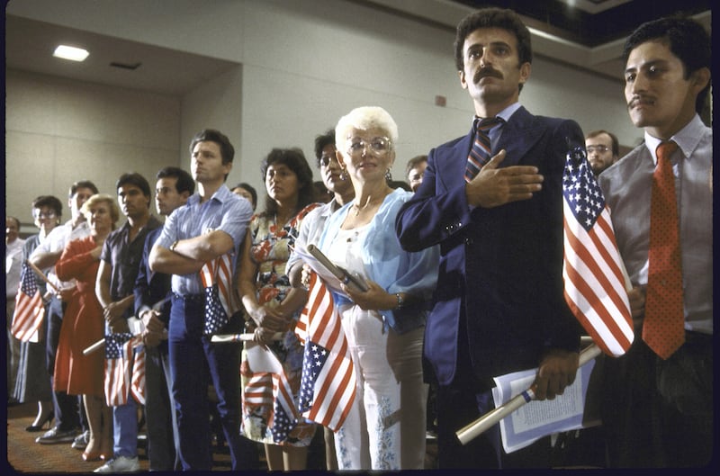 New citizens participating in swear-in ceremony during Constitutional Bicentennial fete.