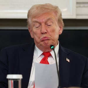 WASHINGTON, DC - OCTOBER 08: U.S. President Donald Trump reads a note handed to him by U.S. Secretary of State Marco Rubio he said was regarding Middle East peace talks during a roundtable discussion in the State Dining Room of the White House on October 08, 2025 in Washington, DC. Trump’s administration held the roundtable to discuss the anti-fascist Antifa movement after signing an executive order designating it as a “domestic terrorist organization”. (Photo by Anna Moneymaker/Getty Images)