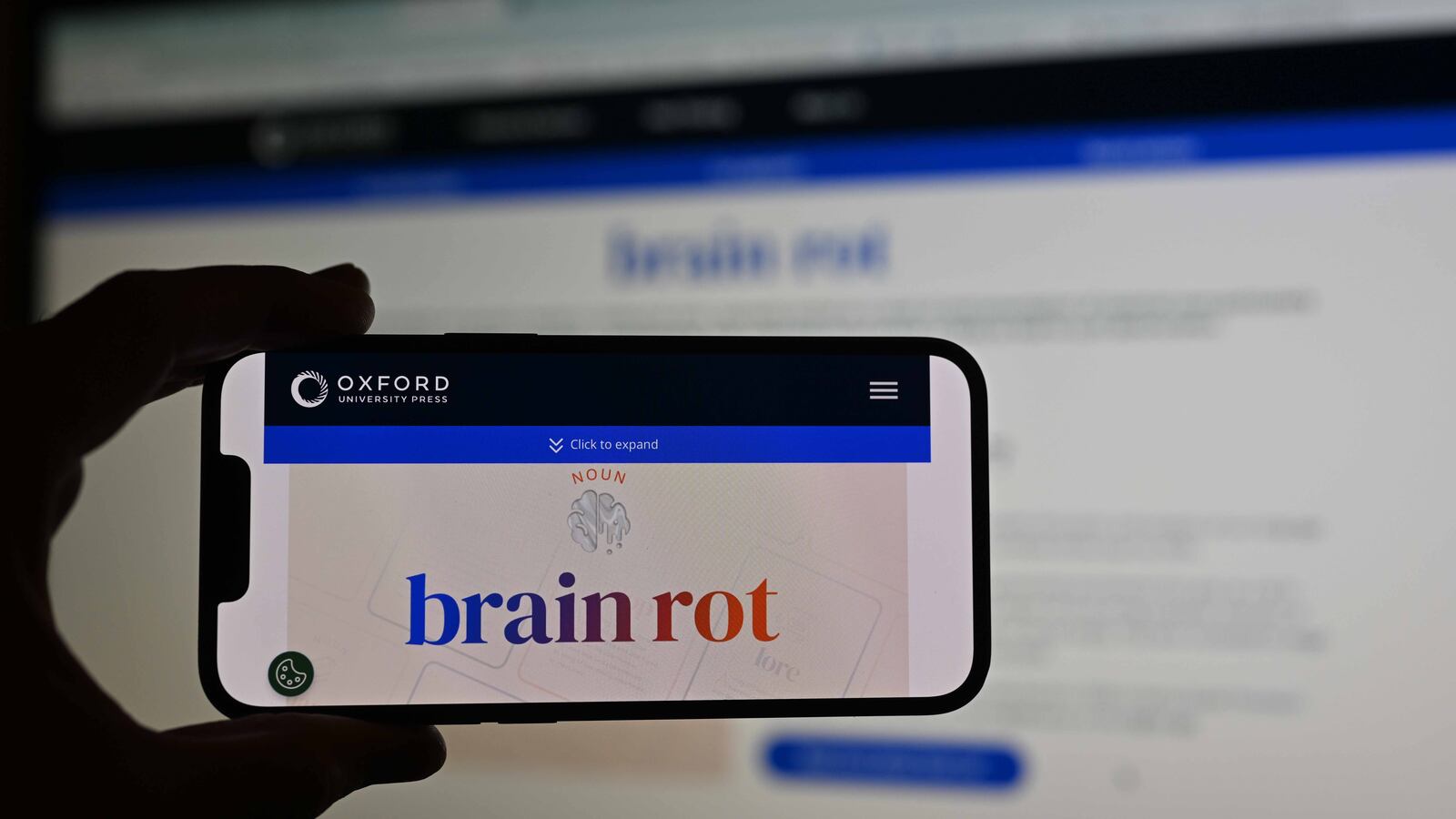 A man holds a phone, displaying word of ''brain rot'', as the Oxford Dictionary has chosen the word, which refers to the unnecessary and entertaining use of social media, as the word of the year in London, United Kingdom on December 2, 2024.