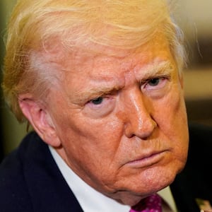 U.S. President Donald Trump looks on as he speaks to members of the media aboard Air Force One en route to Joint Base Andrews, Maryland, U.S., March 29, 2026.