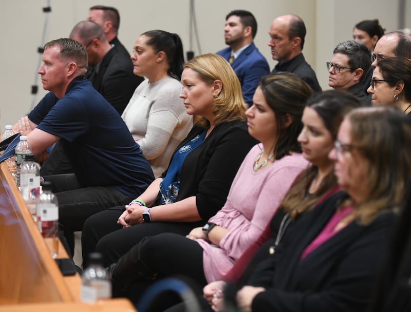 Families of Sandy Hook victims sit in the front row as Infowars founder Alex Jones testifies during the Sandy Hook defamation damages trial.