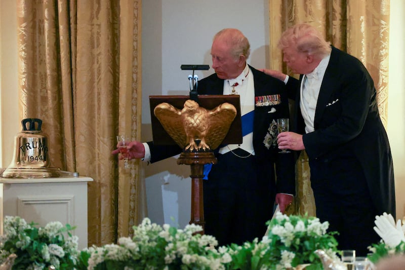 Britain's King Charles points at the bell he presented to U.S. President Donald Trump as a gift during a state dinner for the King and Queen Camilla at the White House in Washington, D.C., U.S., April 28, 2026.