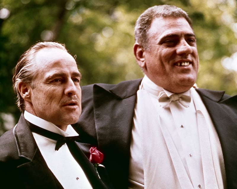 American actors Marlon Brando (1924 - 2004) (left) (as Don Vito Corleone) and Lenny Montana (1926 - 1992) (as Luca Brasi) in a scene from 'The Godfather' (directed by Francis Ford Coppola), New York, New York, 1972. (Photo by Silver Screen Collection/Getty Images)