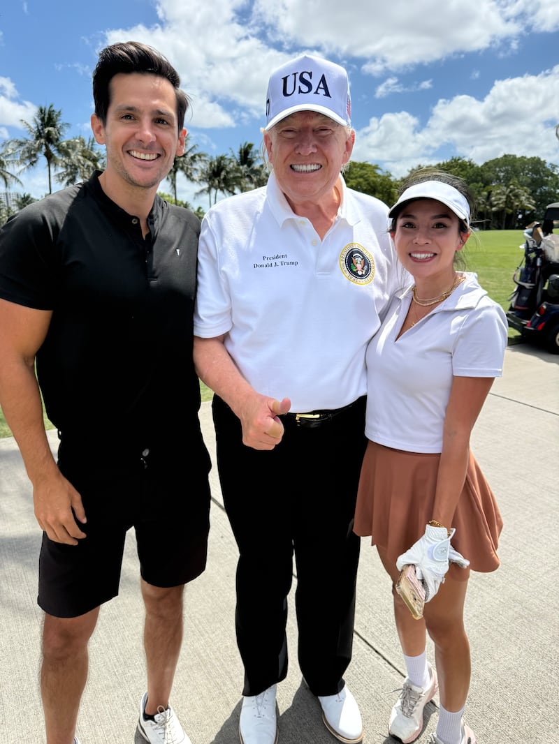 Despite hating handsome men, Trump posed for a photo with Nina's husband, Mark.