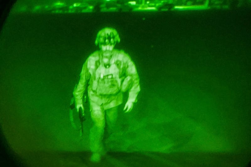 U.S. Army Major General Chris Donahue, commander of the 82nd Airborne Division, steps on board a C-17 transport plane as the last U.S. service member to leave Hamid Karzai International Airport in Kabul, Afghanistan August 30, 2021 in a photograph taken using night vision optics.  XVIII Airborne Corps/Handout via REUTERS. THIS IMAGE HAS BEEN SUPPLIED BY A THIRD PARTY. THIS PICTURE WAS PROCESSED BY REUTERS TO ENHANCE QUALITY. AN UNPROCESSED VERSION HAS BEEN PROVIDED SEPARATELY. REFILE - CORRECTING DATE.