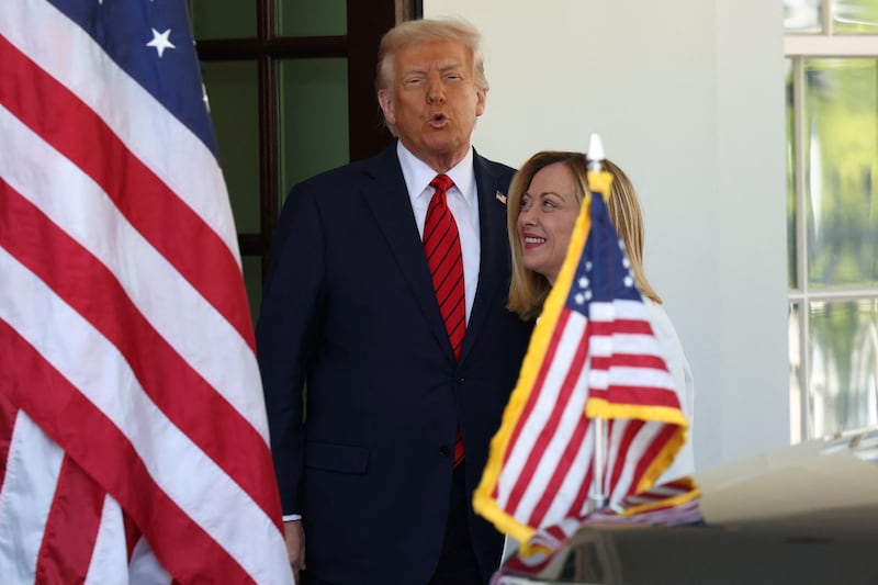 U.S. President Donald Trump greets Italian Prime Minister Giorgia Meloni upon her arrival at the White House in Washington, D.C., U.S., April 17, 2025. REUTERS/Kevin Lamarque