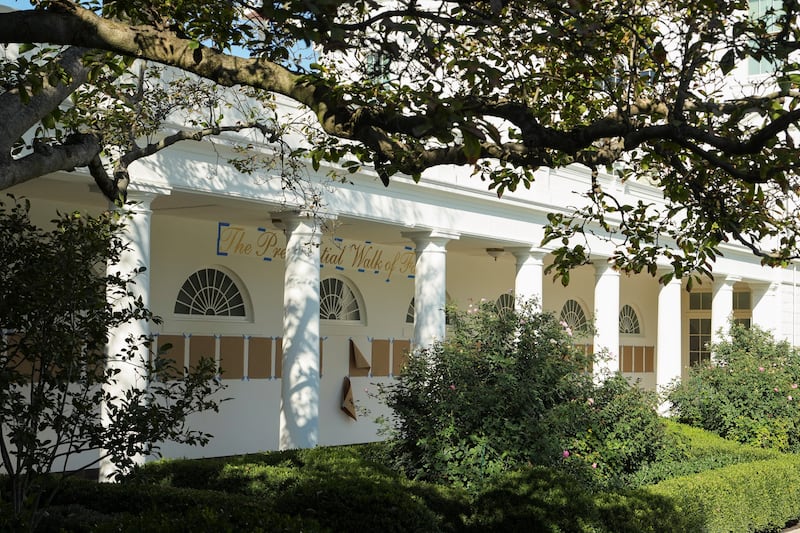 "The presidential walk of fame" is written on a wall, above pieces of brown paper placed in the colonnade outside the Oval Office, at the White House in Washington, D.C., U.S., September 19, 2025. REUTERS/Ken Cedeno