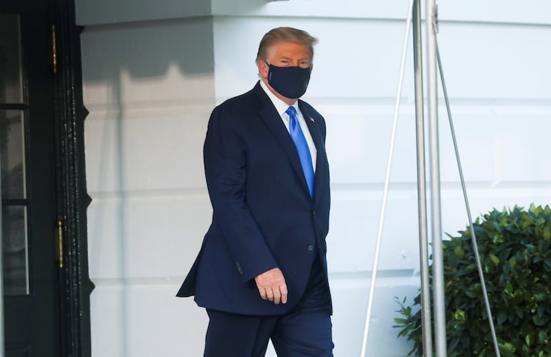 President Trump walks to the Marine One helicopter wearing a protective face mask as he departs the White House to fly to Walter Reed National Military Medical Center on October 2, 2020.