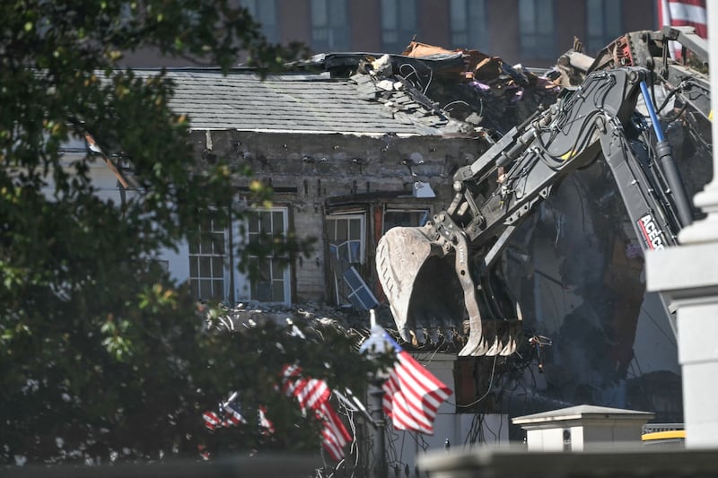 Heavy machinery tears down a section of the East Wing of the White House as construction begins on President Donald Trump's planned ballroom, in Washington, DC, on October 21, 2025.