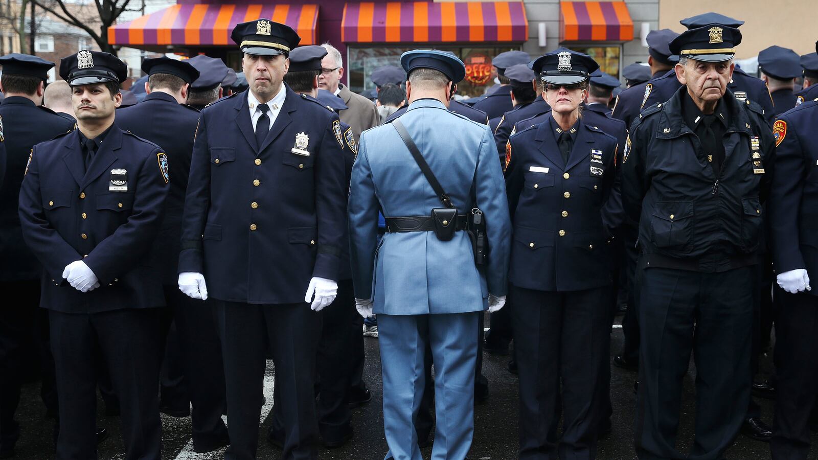 articles/2015/01/05/an-nypd-family-s-grief-beats-back-grievances-for-most/150104-lui-funeral3_zfowg6