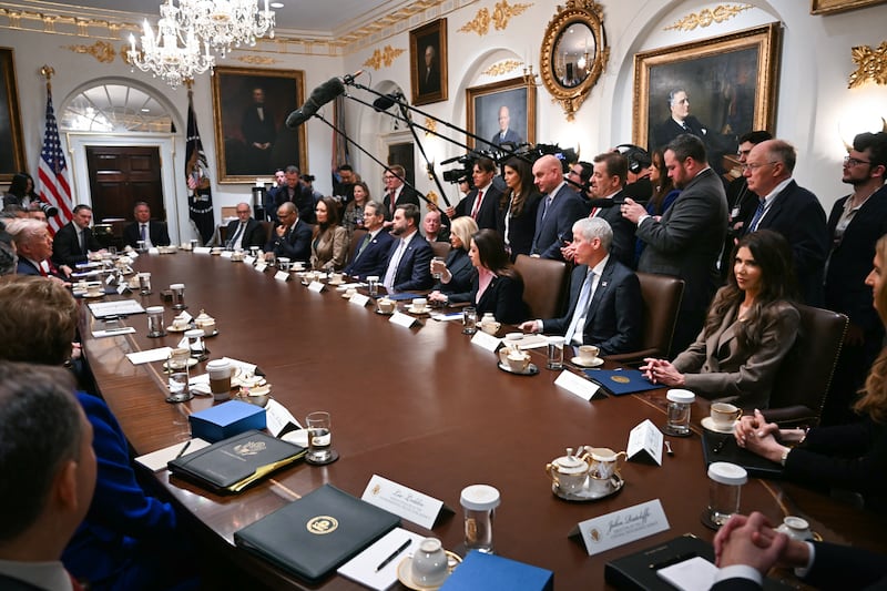Secretary of Homeland Security Kristi Noem (lower R) listens as President Donald Trump hosts a cabinet meeting in the Cabinet Room of the White House in Washington, DC, on January 29, 2026.