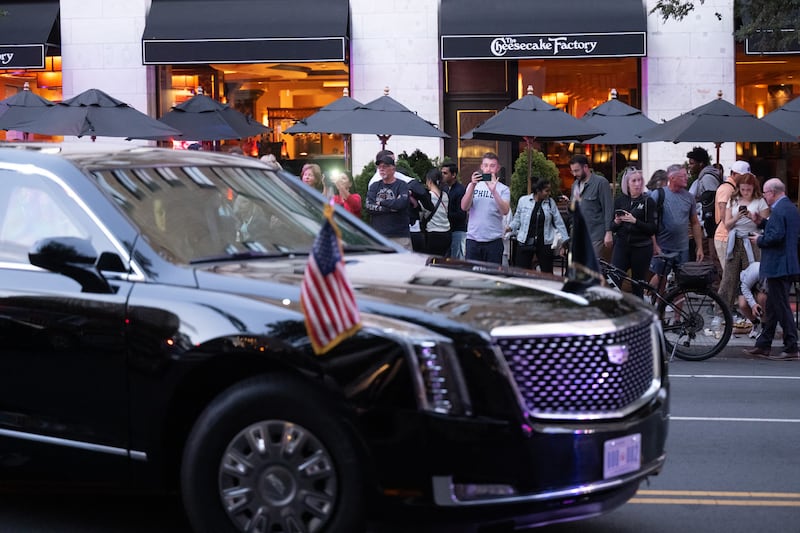 Onlookers take photos of the Presidential limousine outside the restaurant Joe's Seafood, Prime Steak & Stone Crab as the US president and vice president dine there in Washington, DC, on September 9, 2025. (Photo by SAUL LOEB / AFP) (Photo by SAUL LOEB/AFP via Getty Images)