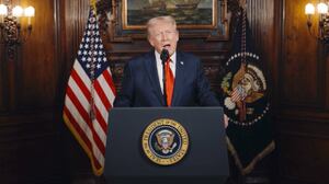 A video screenshot of Donald Trump speaking at a lectern.