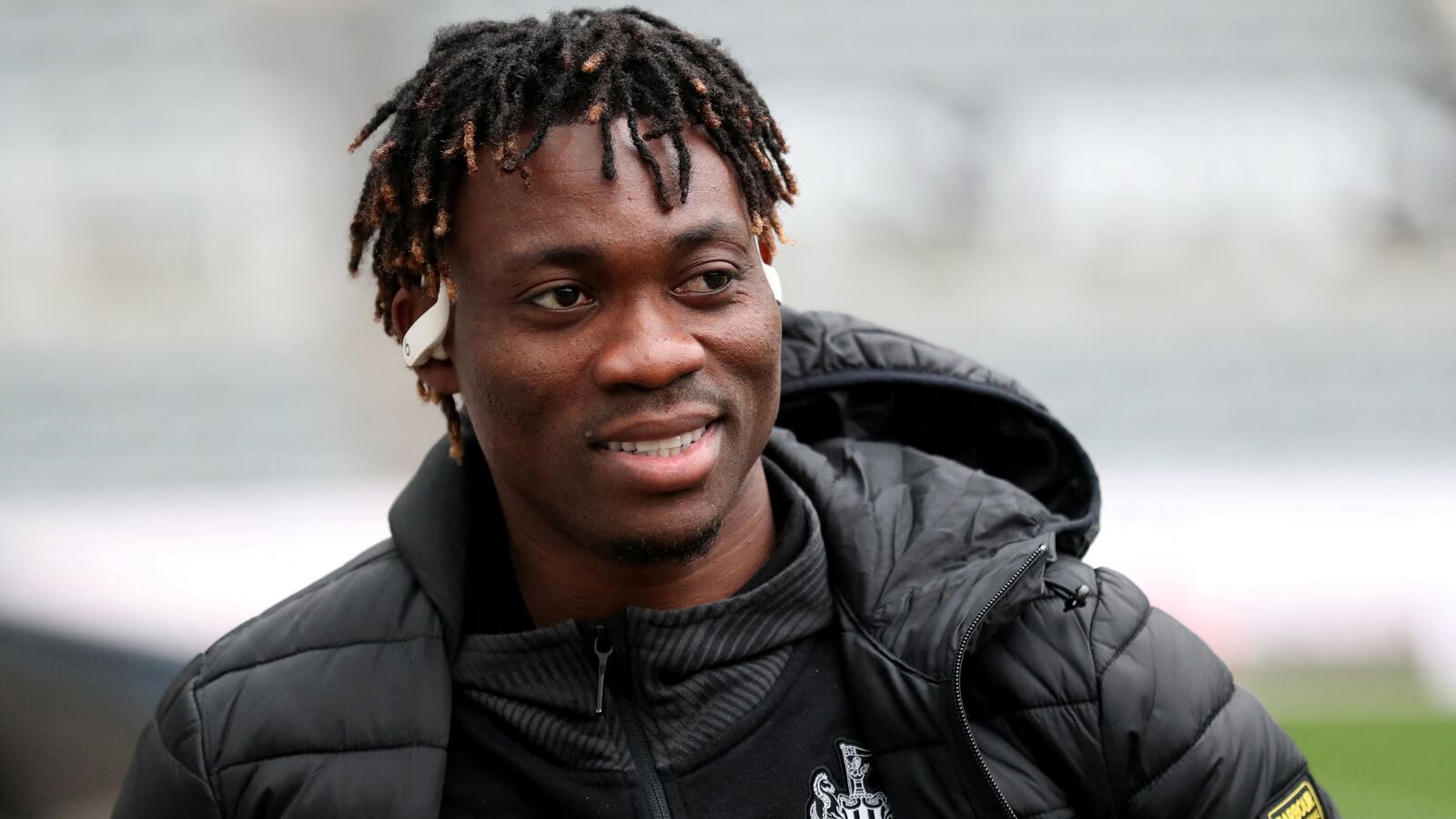 Christian Atsu wears Newcastle United gear on the field.