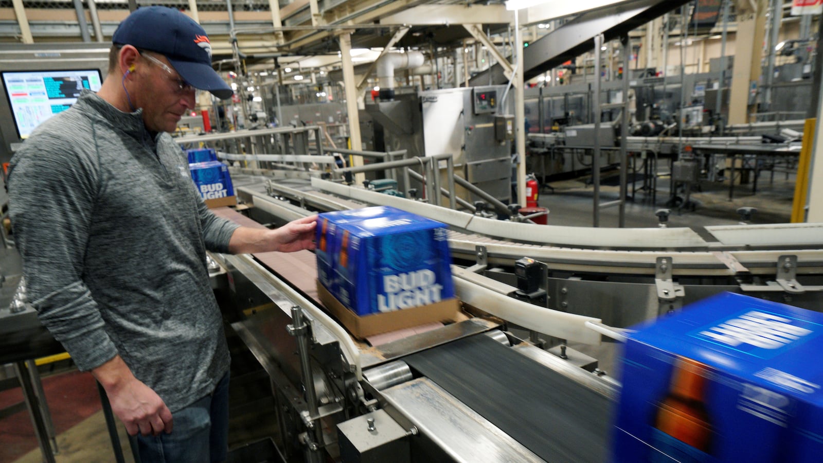 Gene Bocis, general manager for the Anheuser-Busch brewery watches cases of Bud Light beer move down a conveyor belt in Fort Collins, Colorado March 2, 2017.