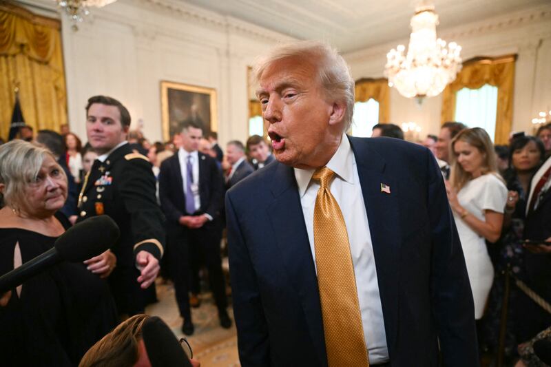 President Donald Trump speaks to reporters after signing the "Halt All Lethal Trafficking of Fentanyl Act," which strengthens prison sentences for fentanyl traffickers, in the East Room of the White House in Washington, DC,