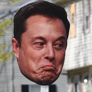 WELLESLEY, MA - APRIL 21: A spectator holds up a sign with a picture of Elon Musk's face during the 129th Boston Marathon on April 21, 2025, in Wellesley, MA. (Photo by Erica Denhoff/Icon Sportswire via Getty Images)