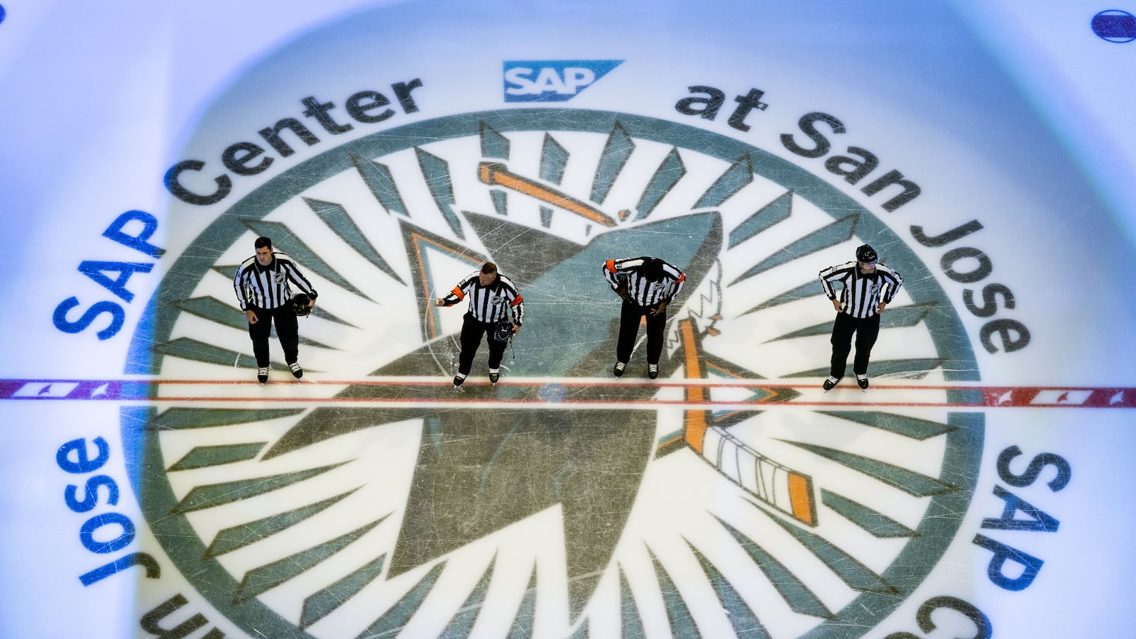 SAN JOSE, CA - OCTOBER 14: referee's stand at center ice for the American Anthem before a NHL game between the Carolina Hurricanes and the San Jose Sharks on October 14, 2025 at SAP Center in San Jose, CA. (Photo by Trinity Machan/Icon Sportswire via Getty Images)