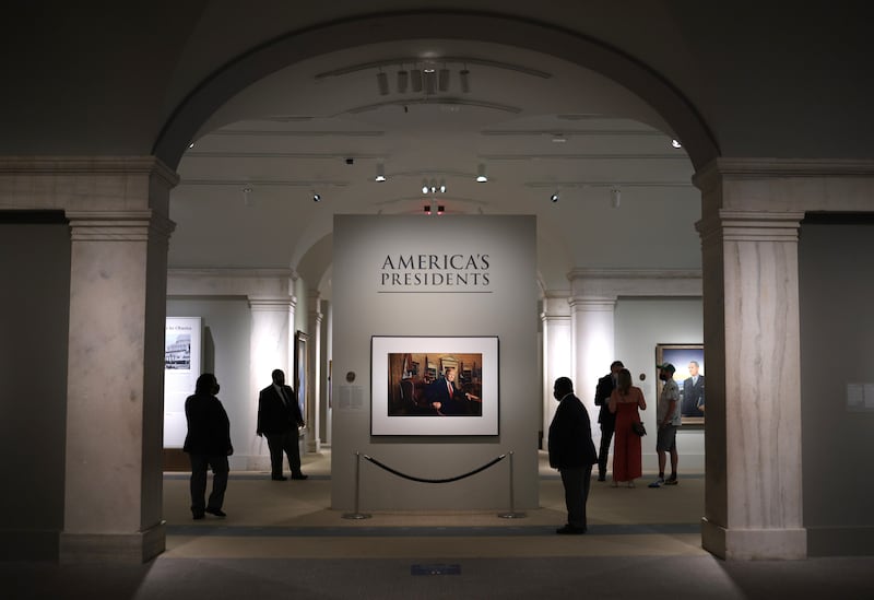 WASHINGTON, DC - MAY 14: Patrons view a portrait of former U.S. President Donald Trump in the America’s Presidents exhibition at the National Portrait Gallery as the Smithsonian Institution begins to slowly re-open its museums May 14, 2021 in Washington, DC. Trump’s portrait, a photograph made by Pari Dukovic is on display to the public for the first time since the closure of the museums due to the coronavirus pandemic.  (Photo by Win McNamee/Getty Images)