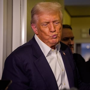 U.S. President Donald Trump, accompanied by U.S. Secretary of State Marco Rubio (R), takes a question from a reporter aboard Air Force One on October 27, 2025, in flight.