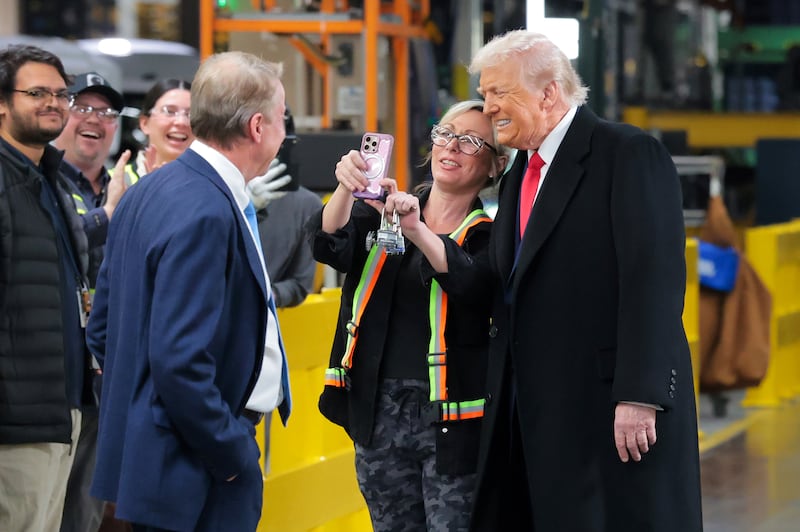U.S. President Donald Trump (R) take a picture with a worker as he tours the Ford River Rouge Complex on January 13, 2026 in Dearborn, Michigan. Trump is visiting Michigan where he will participate in a tour of the Ford River Rouge complex and later give remarks to the Detroit Economic Club.