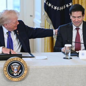 US President Donald Trump speaks with US Secretary of State Marco Rubio (R) during a meeting with US oil companies executives in the East Room of the White House in Washington, DC on January 9, 2026. President Trump is aiming to convince oil executives to support his plans in Venezuela, a country whose energy resources he says he expects to control for years to come. US forces seized Venezuelan president Nicolas Maduro in a sweeping military operation on January 3, with Trump making no secret that control of Venezuela's oil was at the heart of his actions. (Photo by SAUL LOEB / AFP via Getty Images)