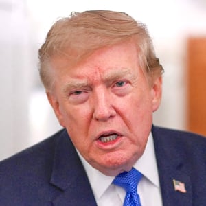 U.S. President Donald Trump speaks to the media aboard Air Force One en route to Joint Base Andrews, in Maryland, U.S., August 2, 2026.
