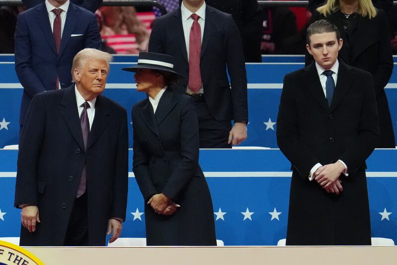 President Donald Trump, first lady Melania Trump, and Barron Trump watch during an indoor inauguration parade at Capital One Arena on January 20, 2025 in Washington, DC. Donald Trump takes office for his second term as the 47th president of the United States.