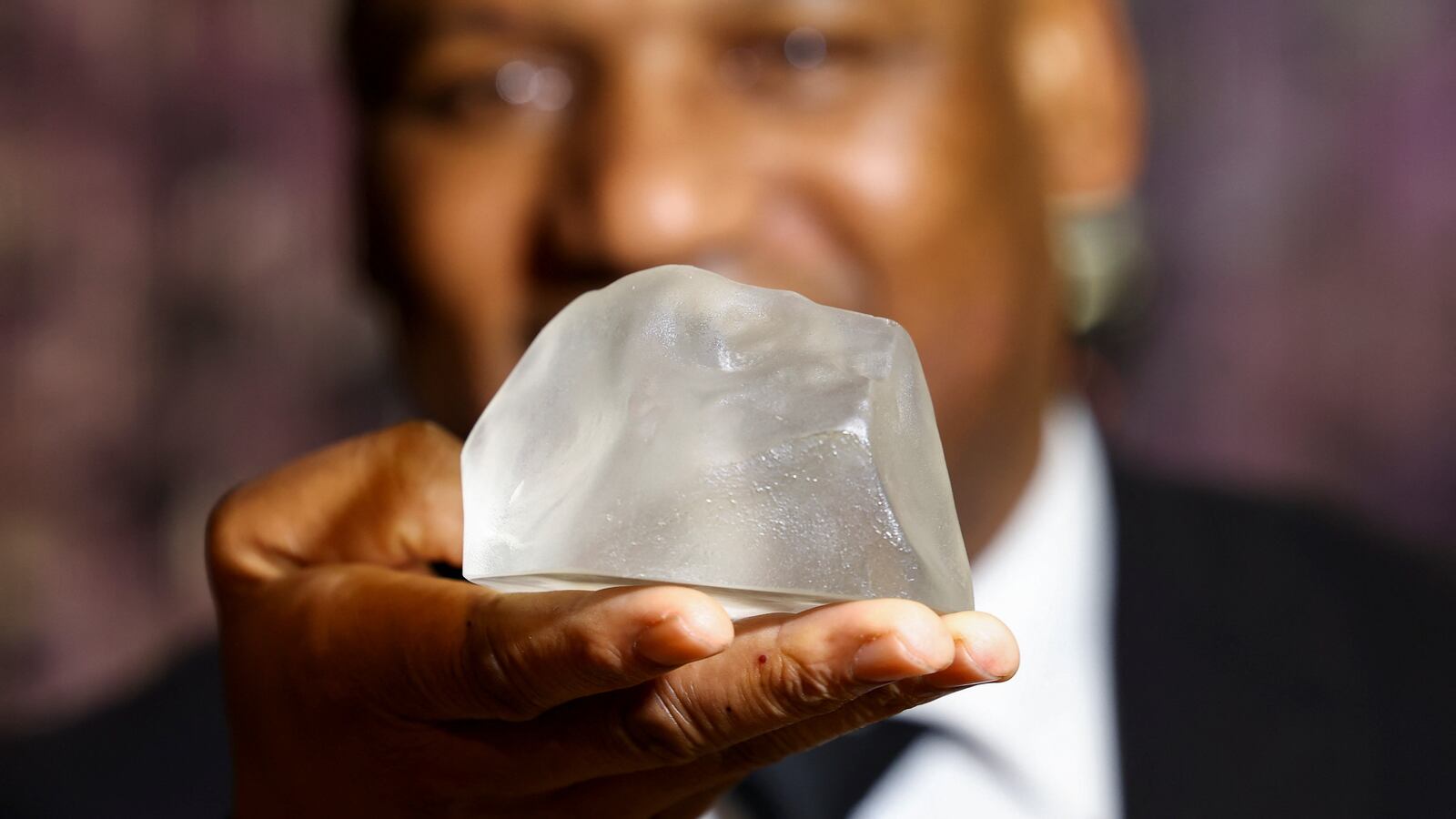 Pule Musi, a staff member, shows a replica of the Cullinan Diamond, the largest gem-quality rough diamond, displayed at the Cape Town Diamond Museum, in Cape Town, South Africa, April 28, 2023.