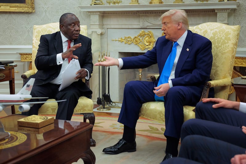 WASHINGTON, DC - MAY 21: U.S. President Donald Trump and South Africa President Cyril Ramaphosa talk to each other during a press availability in the Oval Office at the White House on May 21, 2025 in Washington, DC. Relations between the two countries have been strained since Trump signed an executive order in February that claimed white South Africans are the victims of government land confiscation and race-based “genocide,” while admitting some of those Afrikaners as refugees to the United States. Trump also halted all foreign aid to South Africa and expelled the country’s Ambassador to the U.S., Ebrahim Rasool. (Photo by Chip Somodevilla/Getty Images)
