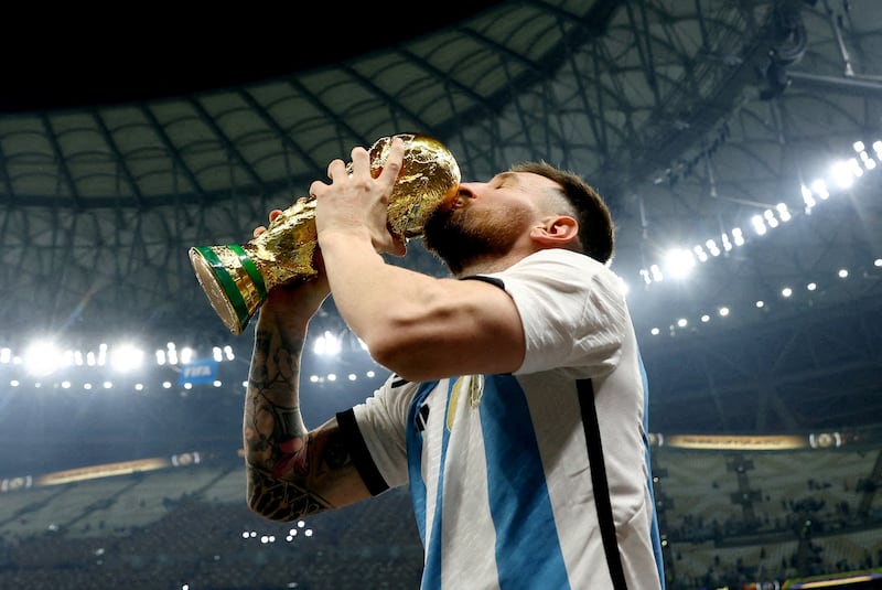 Argentina's Lionel Messi kisses the trophy as he celebrates winning the World Cup.