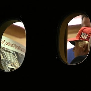 President Donald Trump is seen aboard Air Force One checking a Kennedy Center large printout after landing at Joint Base Andrews, Maryland on September 16, 2026.