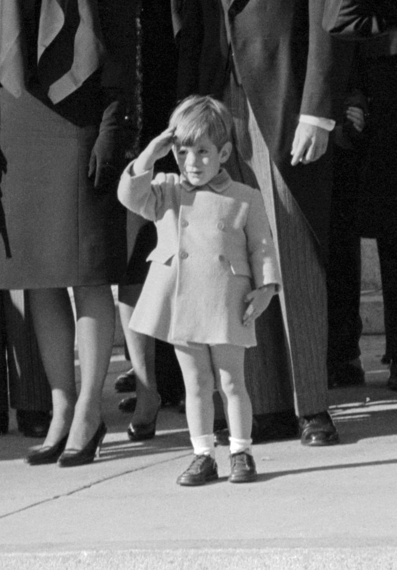 John F. Kennedy Jr., on his third birthday, salutes as the casket of his father, the late President John F. Kennedy, is carried from St. Matthew's Cathedral in Washington, DC.
