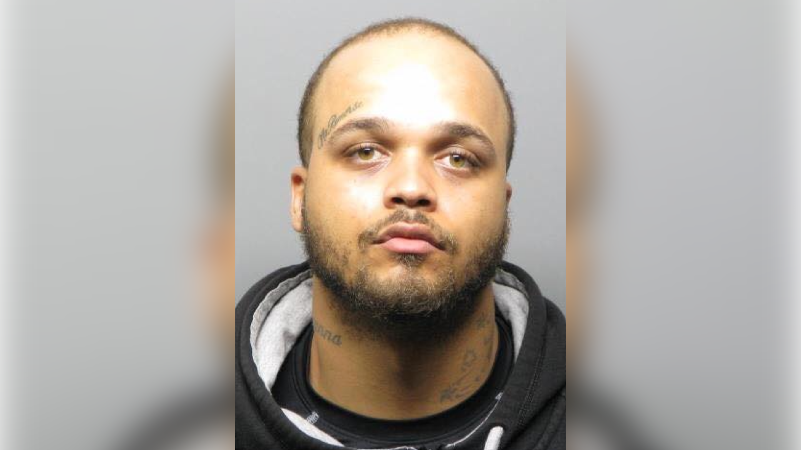 Ramello Randle stares forward in a mugshot.