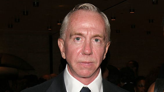 Brent Sikkema stares forward while posing in a suit and tie.