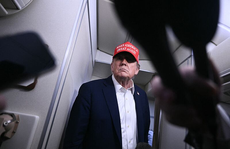 US President Donald Trump speaks to journalists aboard Air Force One after departing Joint Base Andrews, Maryland on his way to Bedminster, New Jersey on July 4, 2025.