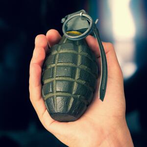 Hand grenade and black background.