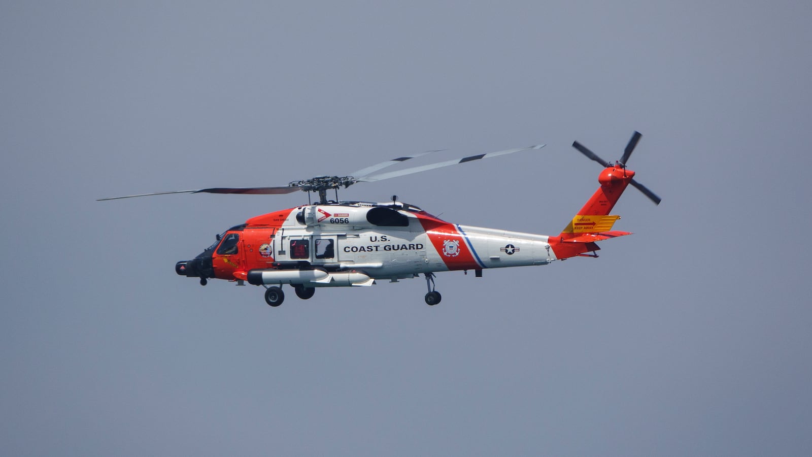 SAN DIEGO, CALIFORNIA - JUNE 28: A U.S. Coast Guard Sikorsky MH-60T Jayhawk helicopter flies to the U.S. Coast Guard Sector San Diego air station on June 28, 2025 in San Diego, California. (Photo by Kevin Carter/Getty Images)