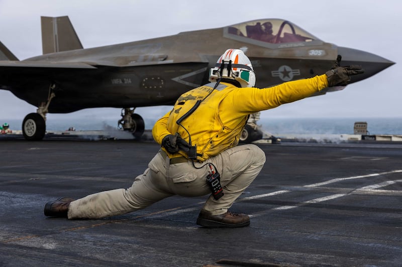 An American sailor directs the pilot of an F-35C Lightning II from the flight deck of the USS Abraham Lincoln earlier this month.