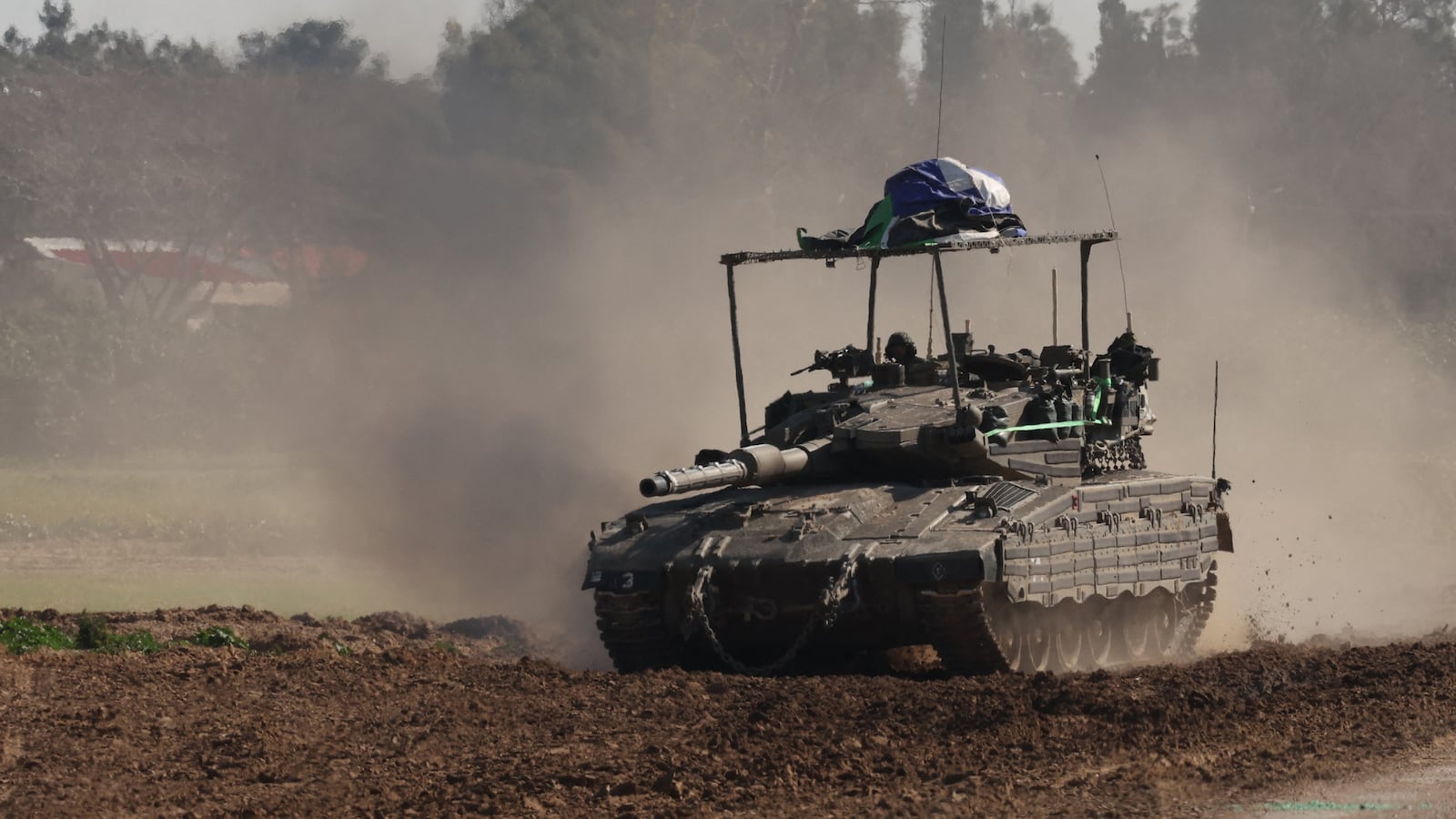 An Israeli army tank rolls along the border with the Gaza Strip in southern Israel