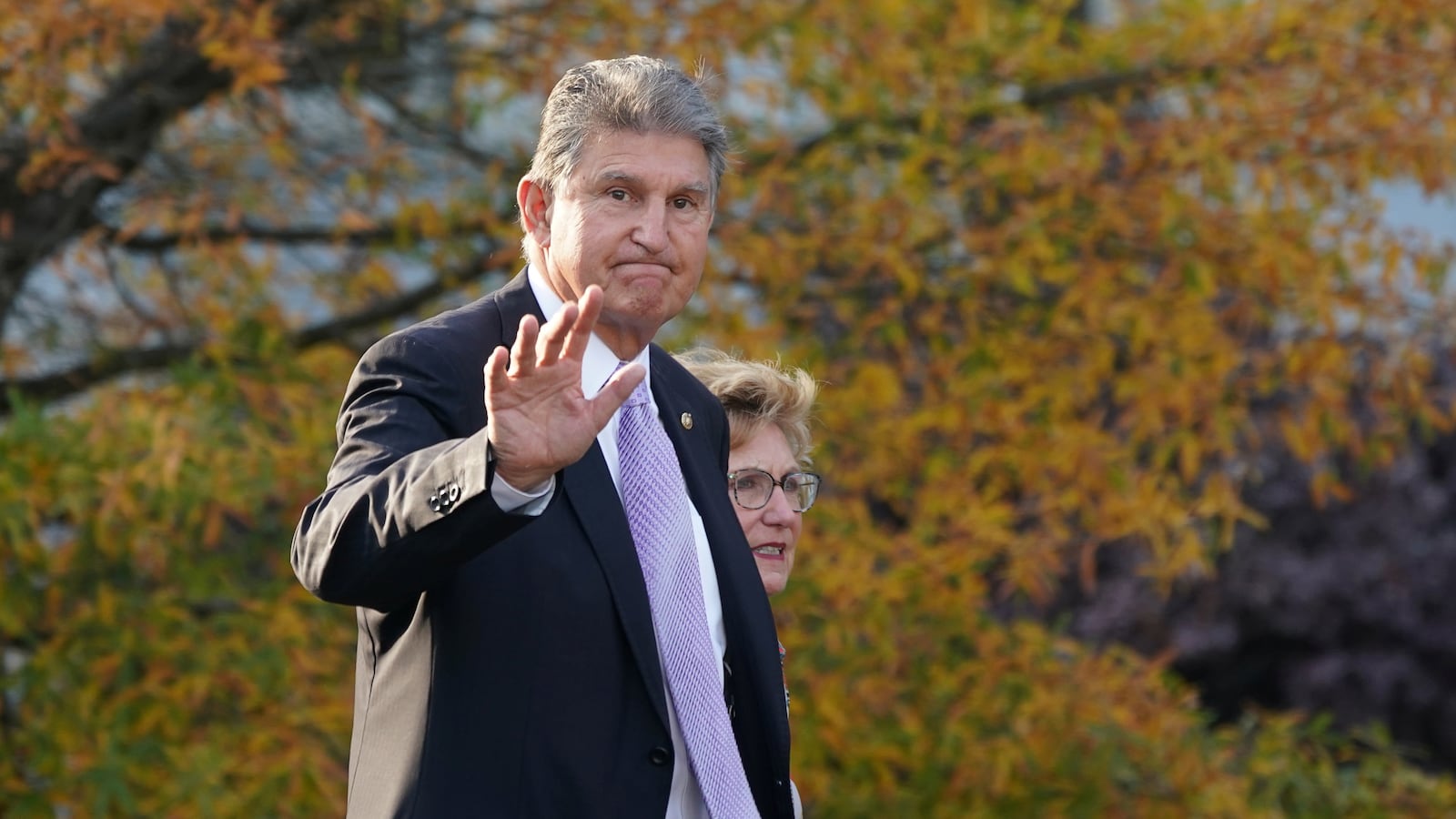 Senator Joe Manchin (D-WV) waves while walking outside the West Wing of the White House in Washington, DC.
