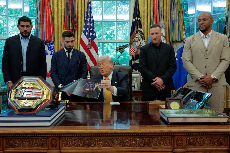 U.S. President Donald Trump shows an image of the concept for the Ultimate Fighting Championship planned for June 14, 2026, as he holds an event with UFC fighters Alex Pereira, Ciryl Gane, Justin Gaethje and Ilia Topuria in the Oval Office at the White House