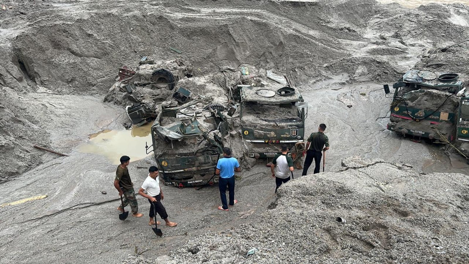 Members of Indian Army try to recover trucks buried at the area affected by flood in Sikkim in this undated image released by the Indian Army on October 5, 2023.