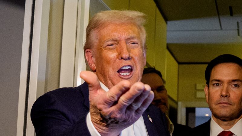 President Donald Trump, accompanied by U.S. Secretary of State Marco Rubio (R) and U.S. Treasury Secretary Scott Bessent (L), speaks to members of the media aboard Air Force One on October 27, 2025, in flight. Trump is in route to Japan after attending the Association of Southeast Asian Nations (ASEAN) summit in Malaysia,