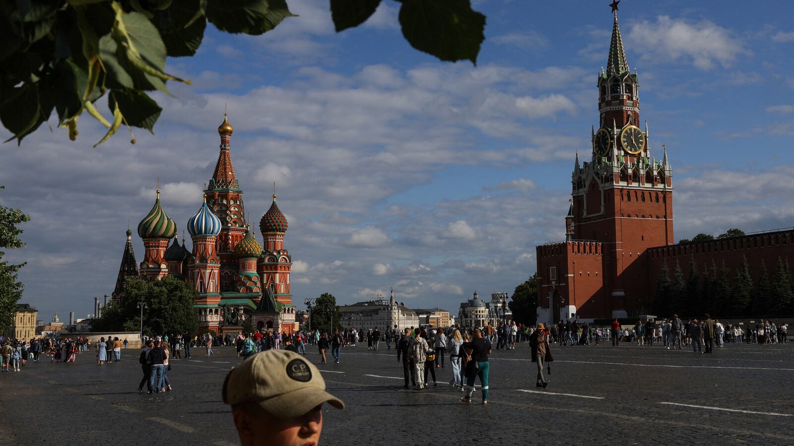 People walk near St. Basil’s Cathedral and the Kremlin’s Spasskaya Tower in Red Square in central Moscow, Russia, July 19, 2023.