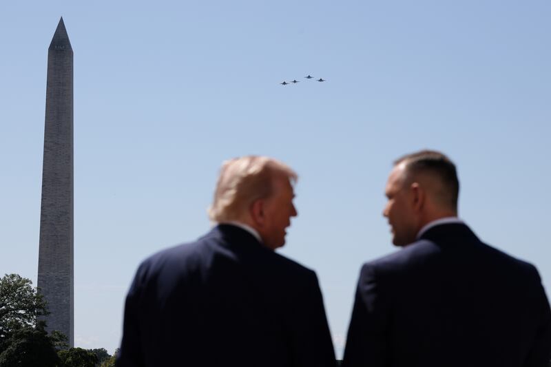 Military aircraft conduct a flyover as U.S. President Donald Trump (L) welcomes Polish President Karol Nawrocki to the White House